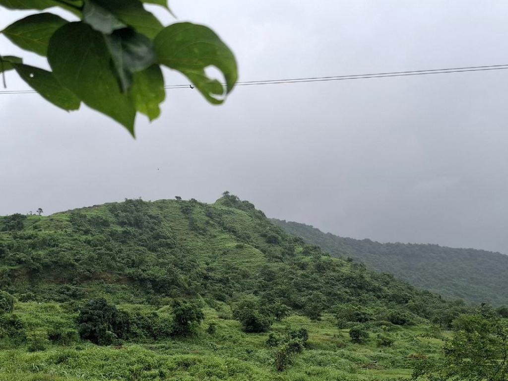 Kharghar Hills from highway is visible in this image.