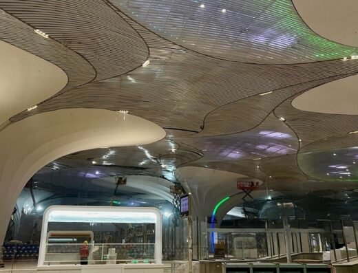 The stunning, lotus-inspired ceiling of the new DB Patil International Airport terminal, showing the unique architectural design and lighting in the main hall.