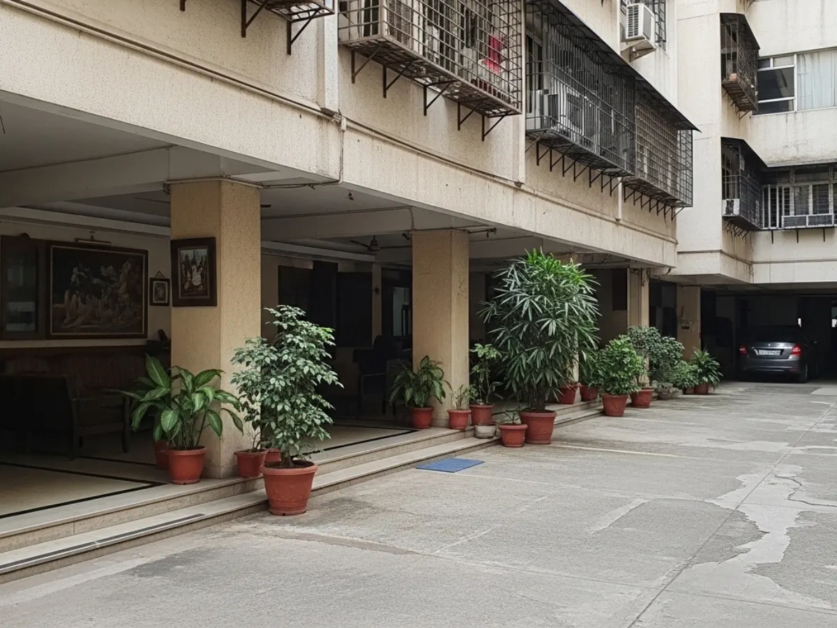 Newer peripheral commercial office complex in CBD Belapur with larger buildings, structured parking, and wider approach roads