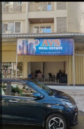 AVS Real Estate Taloja entrance is visible in this image.